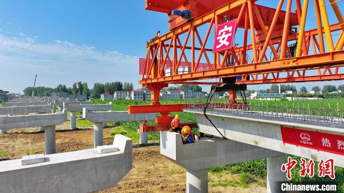 長25米重80噸的箱梁平穩(wěn)、精準地落在S314分離式立交橋25號和26號墩上?！⒂癫?攝